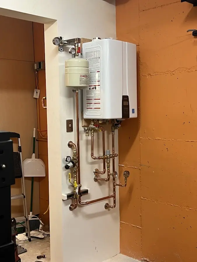 Plumbing technician inspecting water heater connections in Petaluma